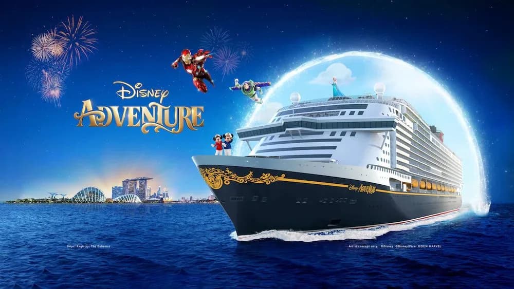 The Disney Adventure cruise ship at sea off the Singapore skyline
