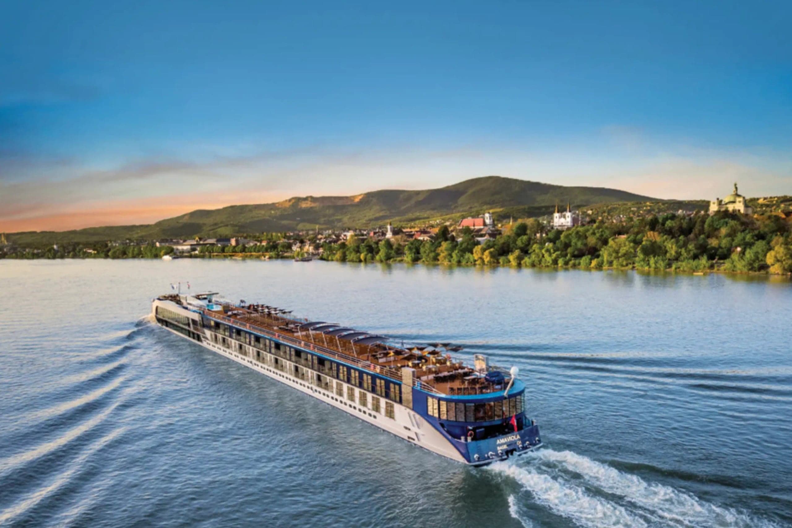 An AmaWaterways river ship cruising the Danube at dusk