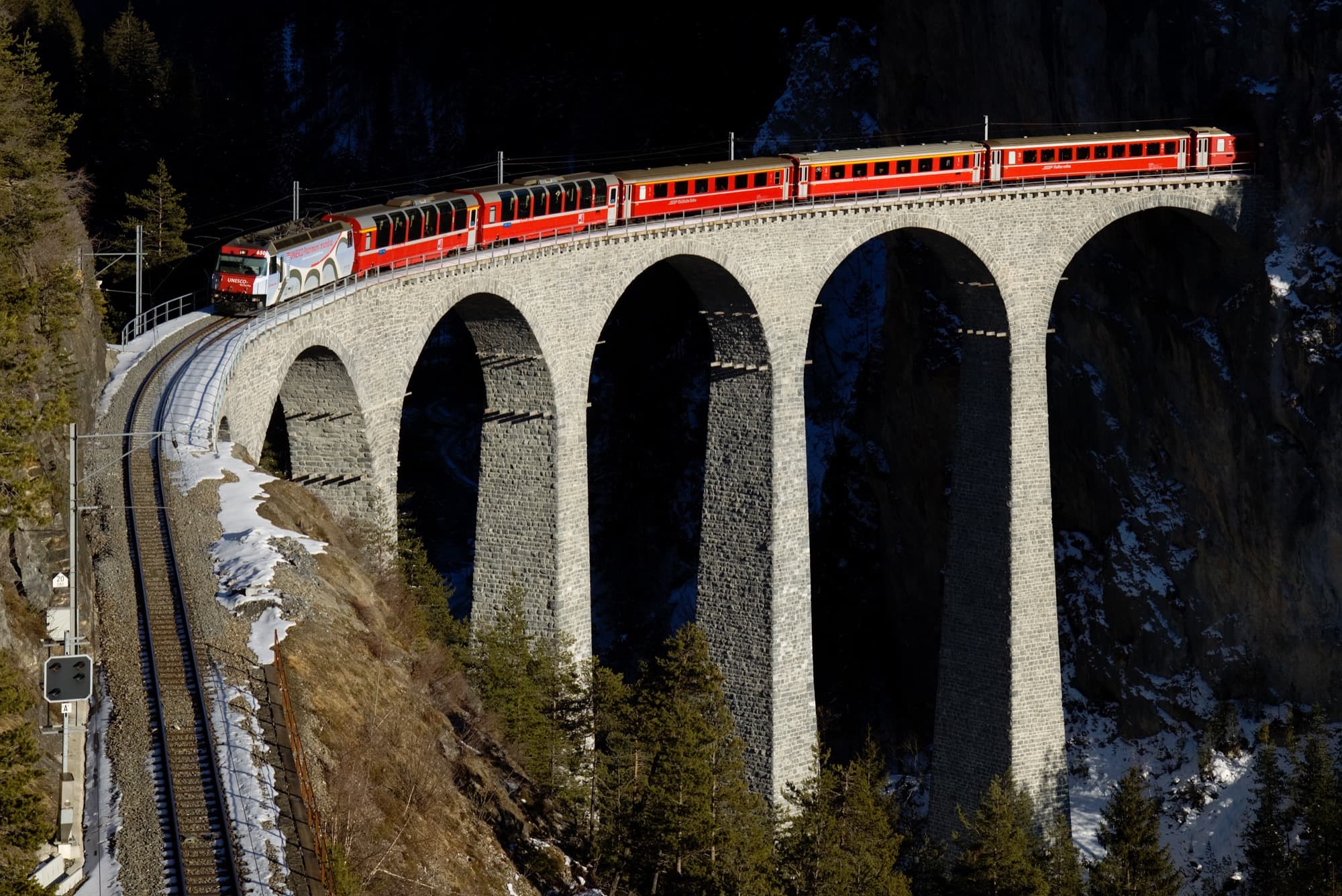 The Glacier Express crossing the Landwasser Viaduct in fresh snow